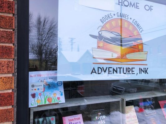 Adventure, Ink shop window with a number of books including How Happy Is a Lark?